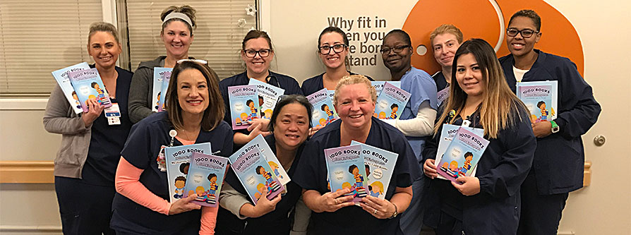 Nurses holding up children's books