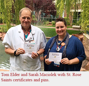 Tom Elder and Sarah Maciolek with St. Rose Saints certificates and pins