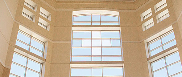 Inside of building with windows to blue sky