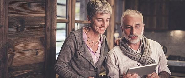 Senior couple inside a cabin looking at a computer