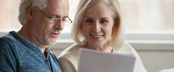 photo of two seniors reading a document